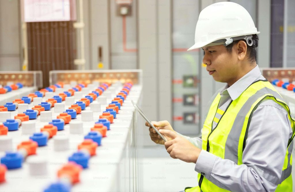 Engineer inspecting industrial battery system